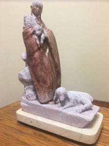 stone sculpture of a Navajo Woman with sheep by Oreland Joe