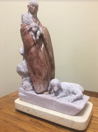 stone sculpture of a Navajo Woman with sheep by Oreland Joe